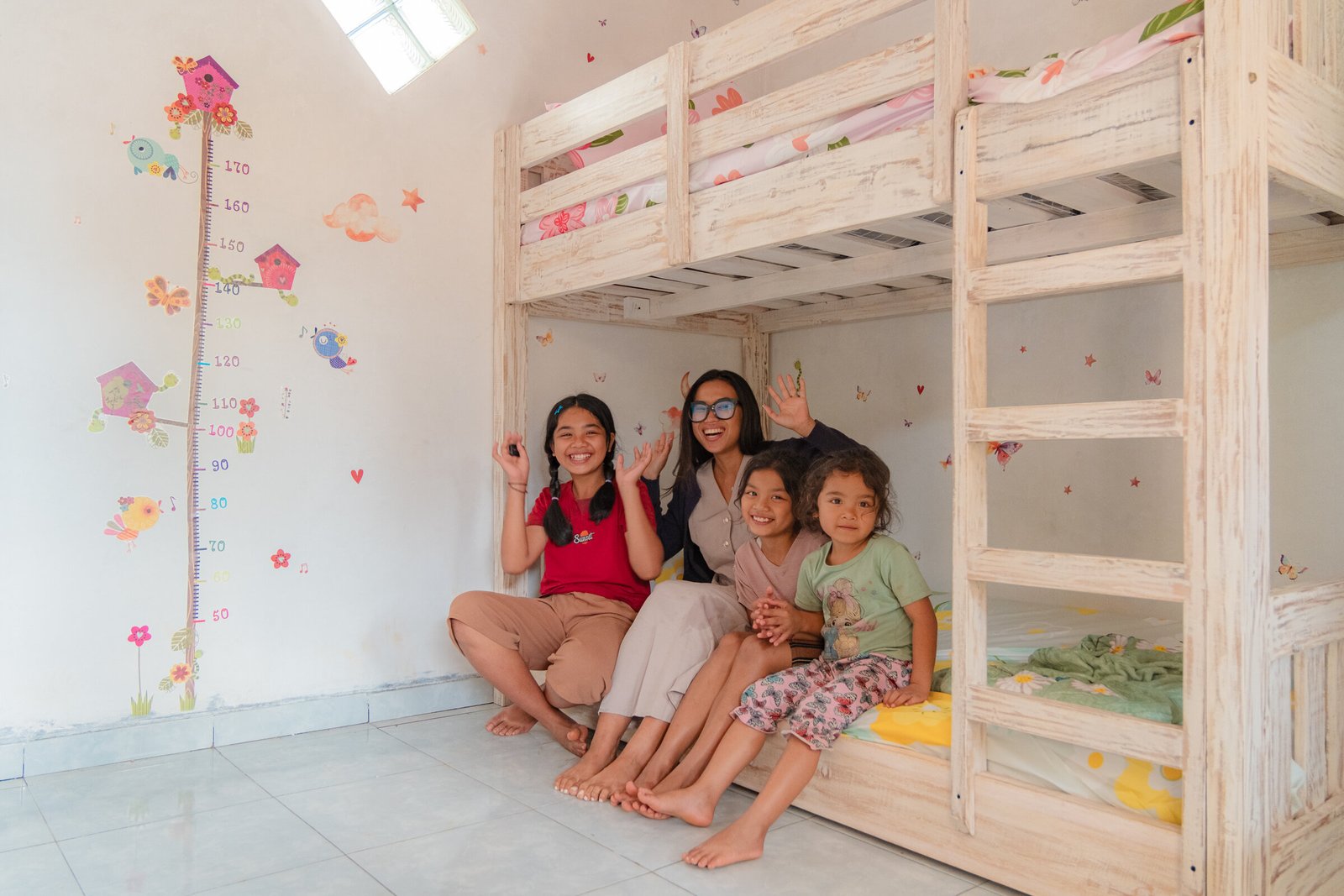 A KGM volunteer with a family in their new home