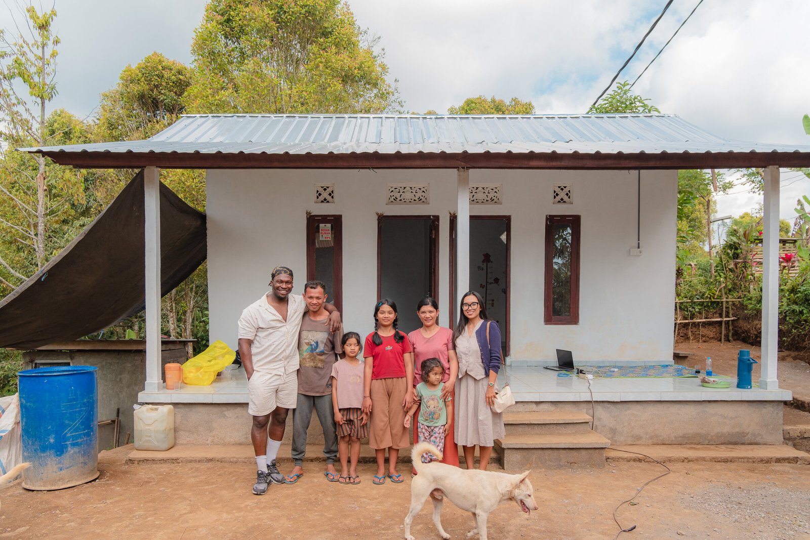 A family and volunteers outside their newly built home